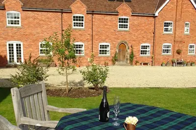 a table with a bottle of wine on top of it at The Old Coach House in Llangollen