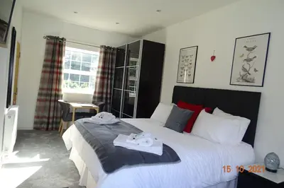 a bedroom with a large bed with towels on it at The Old Coach House in Llangollen