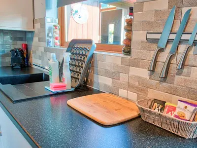a kitchen counter with a cutting board and knives at Arenig - Bala Lake in Bala
