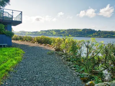 a gravel path next to a body of water at Arenig - Bala Lake in Bala