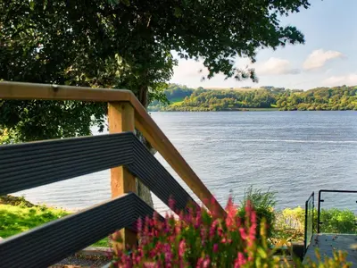 a wooden staircase with a view of a lake at Arenig - Bala Lake in Bala