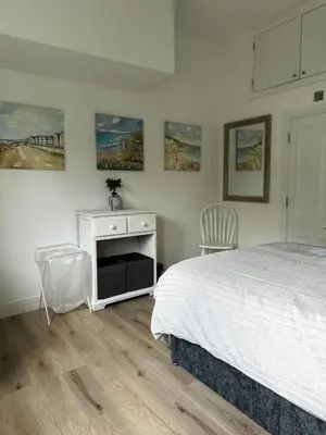 a bedroom with a bed and a desk and paintings on the wall at Flat 2 The Butlers Quarters in Oswestry