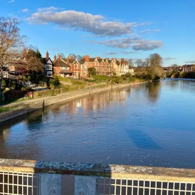 a view of a river with houses and buildings at The Old Stables, The River Severn, Shrewsbury in Shrewsbury