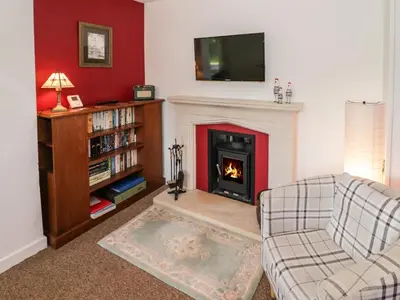 a living room with a fireplace and a tv at 3 Oaks Lodge in Shrewsbury