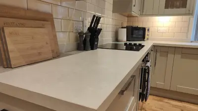 a kitchen with a white counter top and a microwave at 1 Chapel Nazareth in Penrhyndeudreath