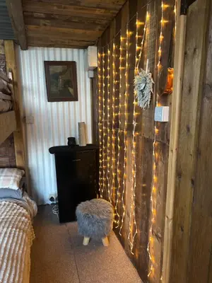 a bedroom with a wall with lights on it at Bridie -rose with wood tub country retreat in Kington