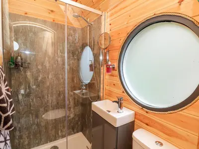 a bathroom with a sink and a mirror at The Kites Nest in Ystrad Meurig