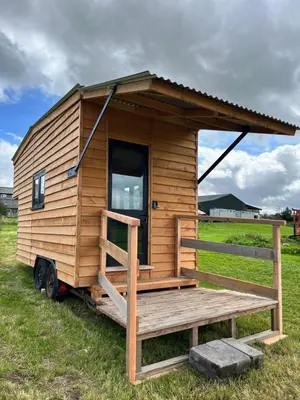 a tiny house on a trailer in a field at Beaver Tail Cabin in Hereford