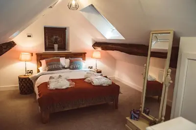 a bedroom with a bed with two animals on it at The Granary in Montgomery