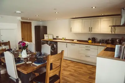 a kitchen with a table and a dining room at The Granary in Montgomery