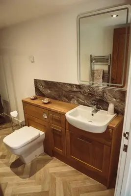 a bathroom with a sink and a toilet and a mirror at The Granary in Montgomery