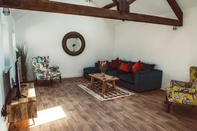 a living room with a blue couch and a table at The Granary in Montgomery