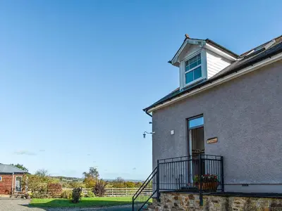 a building with a balcony and a window on it at Cartws Blaenparc Coach House - Uk41031 in Mydroilin