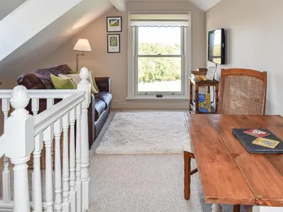 a living room with a couch and a table at Cartws Blaenparc Coach House - Uk41031 in Mydroilin
