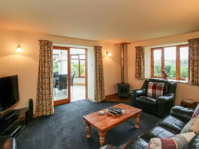 a living room with a couch and a table at Rowan Cottage in Shrewsbury