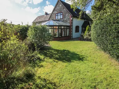 an external view of the house with a lawn at Rowan Cottage in Shrewsbury