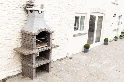 an outdoor brick oven on the side of a building at Penuwch Fach in Aberystwyth