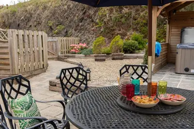 a black table with bowls of food on a patio at Penuwch Fach in Aberystwyth