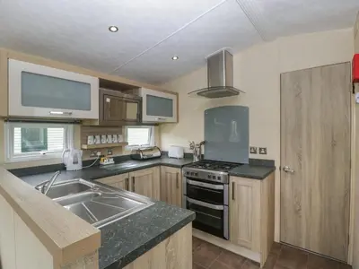 a kitchen with a sink and a stove top oven at Mallard in Leominster
