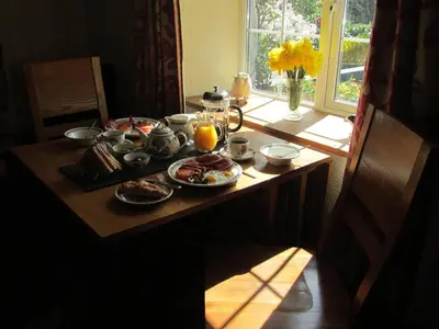 a table with breakfast food and oranges on it at Bryn Sion Farm in Dinas Mawddwy
