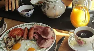 a plate of food with eggs and mushrooms on a table at Bryn Sion Farm in Dinas Mawddwy
