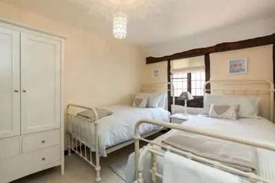 a bedroom with two beds and a dresser at 12A College Hill by Sleep Shrewsbury in Shrewsbury