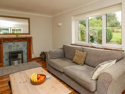a living room with a couch and a table at Rhydygroes in Lampeter