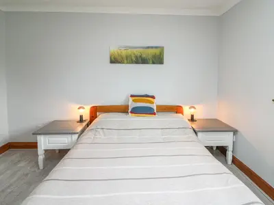 a bedroom with a large bed with two night stands at Rhydygroes in Lampeter