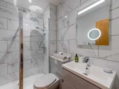 a bathroom with a toilet and a sink and a shower at 5A One Bedroom Modern Town Centre Apartment - Pass the Keys in Shrewsbury