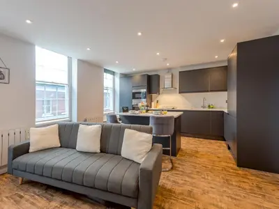 a living room with a couch and a kitchen at 5B One bedrom Central Modern Apartment - Pass the Keys in Shrewsbury
