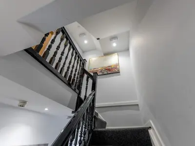 a staircase in a house with a painting on the wall at 5B One bedrom Central Modern Apartment - Pass the Keys in Shrewsbury