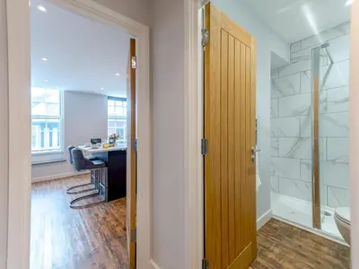 a bathroom with a shower and a toilet and a desk at 5B One bedrom Central Modern Apartment - Pass the Keys in Shrewsbury
