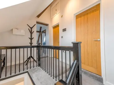 a staircase with a wooden door in a house at 5C Charming Town Centre Apartment With Roof Top Views - Pass the Keys in Shrewsbury