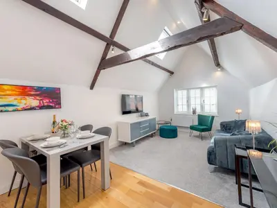 a living room with a table and chairs and a couch at 40C 2 bed Celosia Beautiful Town Centre Apartment - Pass the Keys in Shrewsbury