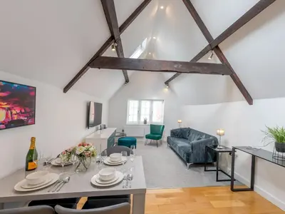 a living room with a table and a couch at 40C 2 bed Celosia Beautiful Town Centre Apartment - Pass the Keys in Shrewsbury