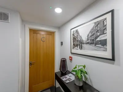a hallway with a door and a picture on the wall at 1 bed 40C Beautiful Town Apartment Celosia - Pass the Keys in Shrewsbury