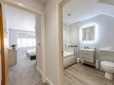 a bathroom with a tub and a toilet and a sink at 1 bed 40C Beautiful Town Apartment Celosia - Pass the Keys in Shrewsbury