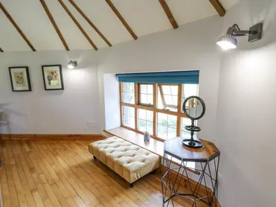 a living room with a couch and a window at Nanthir House in Llandrindod Wells