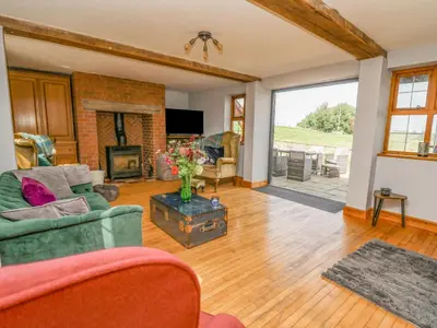 a living room with a couch and a fireplace at Nanthir House in Llandrindod Wells