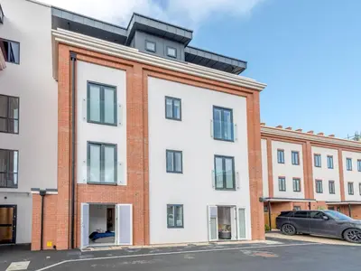 an apartment building with a white facade at Contemporary Apartment with Secure Parking - Pass the Keys in Shrewsbury