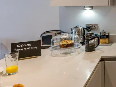 a counter with a glass bowl of food and orange juice at Amaranth Stylish town centre apartment - Pass the Keys in Shrewsbury