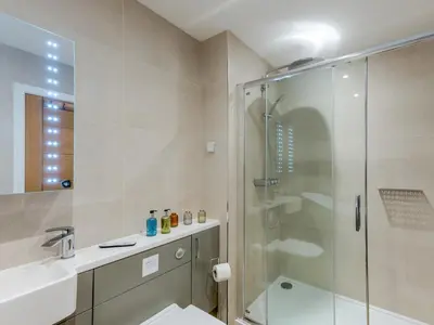 a bathroom with a shower and a toilet and a sink at 1 bed Albury Contemporary Apartment with Secure Parking - Pass the Keys in Shrewsbury