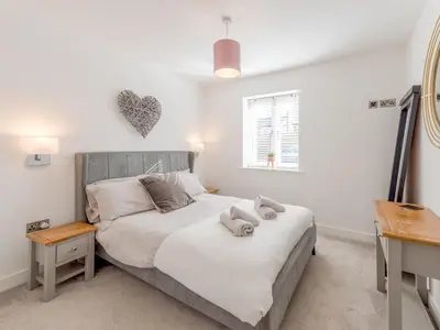 a bedroom with a bed with towels on it at 1 bed Albury Contemporary Apartment with Secure Parking - Pass the Keys in Shrewsbury