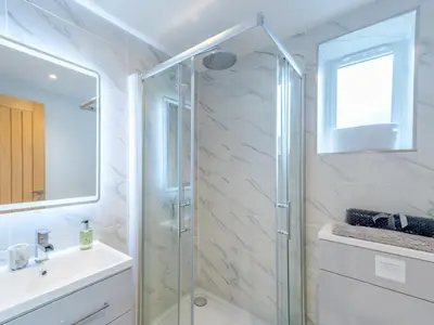 a bathroom with a glass shower and a sink at Bouvardia Modern town centre apartment - Pass the Keys in Shrewsbury