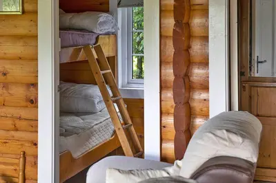 two pictures of a room with a bunk bed and a ladder at Finest Retreats - Mountain View in Trawsfynydd