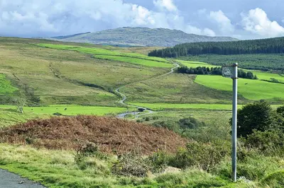 a sign on the side of a hill with a road at Finest Retreats - Mountain View in Trawsfynydd