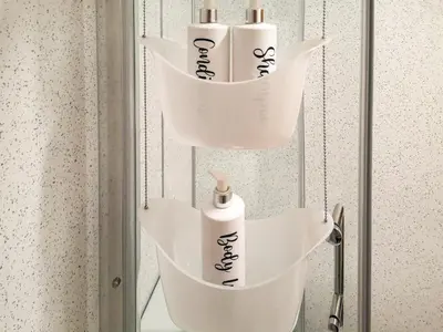 a shelf with three rolls of toilet paper in a bathroom at Cysgod Y Coed in Llanbedr