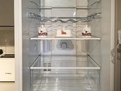 a refrigerator with three white cakes in it at Cysgod Y Coed in Llanbedr