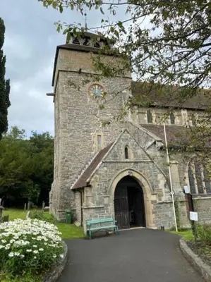 an old stone building with a clock tower at The Garden Room in Knighton