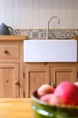 a bowl of apples in a kitchen with a sink at The Garden Room in Knighton
